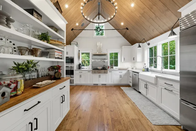 a large kitchen with a lot of counter space and a wooden floor