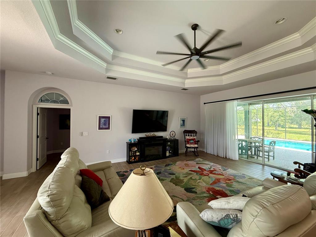 13110 Bamboo Street Spring Hill, FL 34609 - Photo 7 of 56 a living room with furniture and a flat screen tv