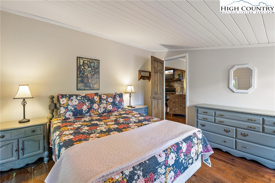 132 Sassafras Deep Gap, NC 28618 - Photo 18 of 33 a bed room with a bed and a dresser