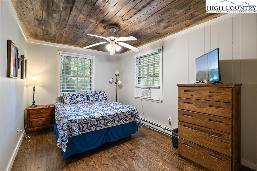 132 Sassafras Deep Gap, NC 28618 - Photo 21 of 33 a bedroom with a bed and a chandelier