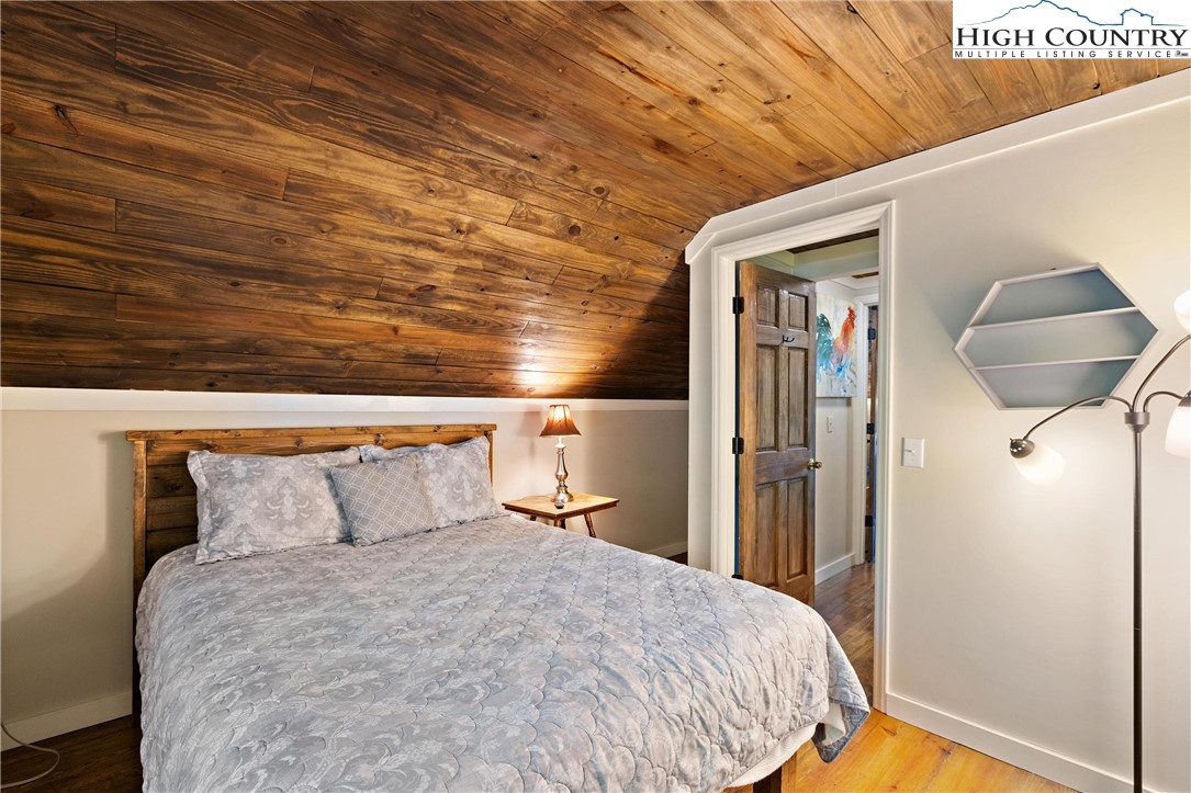 132 Sassafras Deep Gap, NC 28618 - Photo 25 of 33 a bedroom with a bed and a mirror