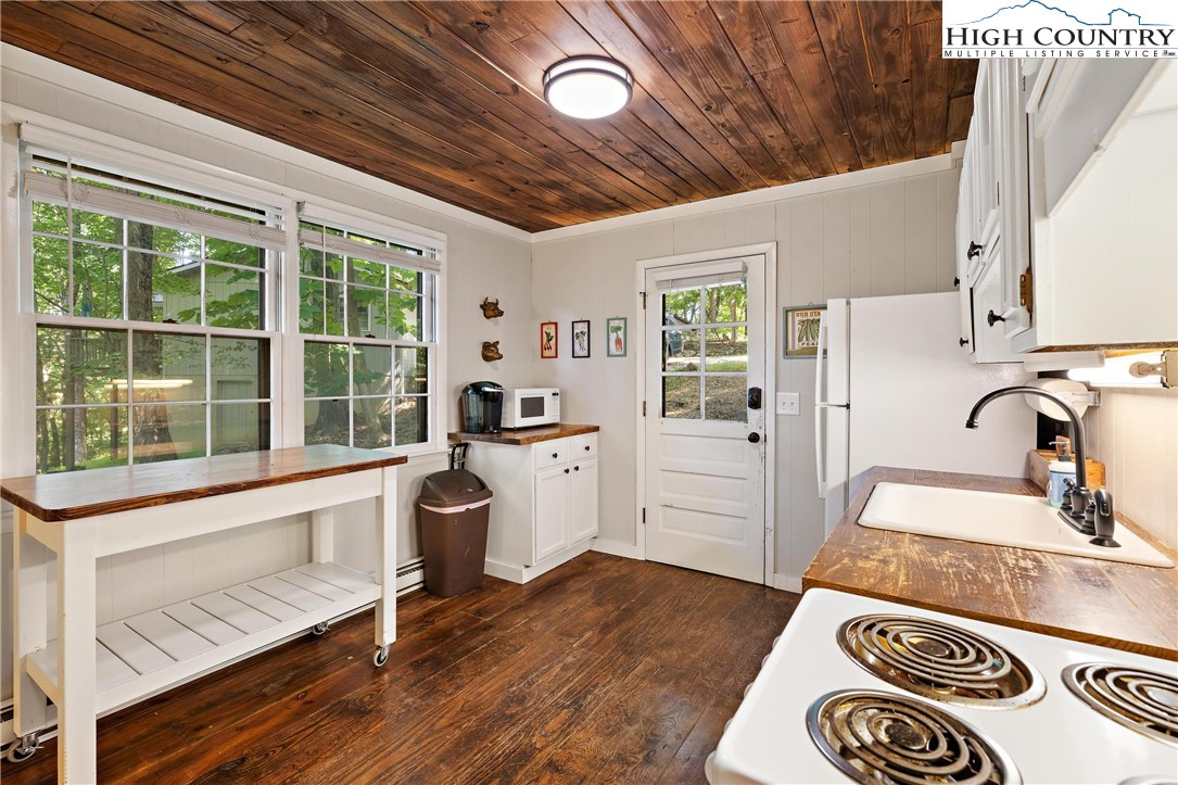 132 Sassafras Deep Gap, NC 28618 - Photo 4 of 33 a kitchen with a stove a sink and a refrigerator