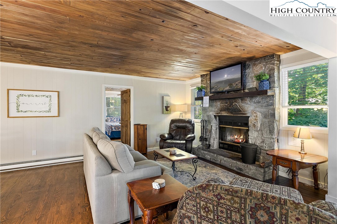 132 Sassafras Deep Gap, NC 28618 - Photo 8 of 33 a living room with furniture a fireplace and a table