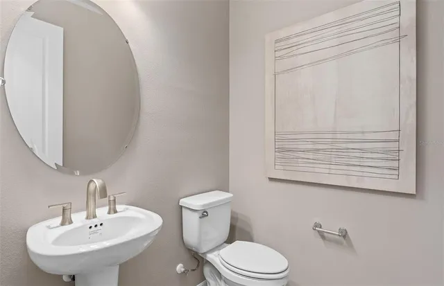 a bathroom with a sink a mirror and a toilet