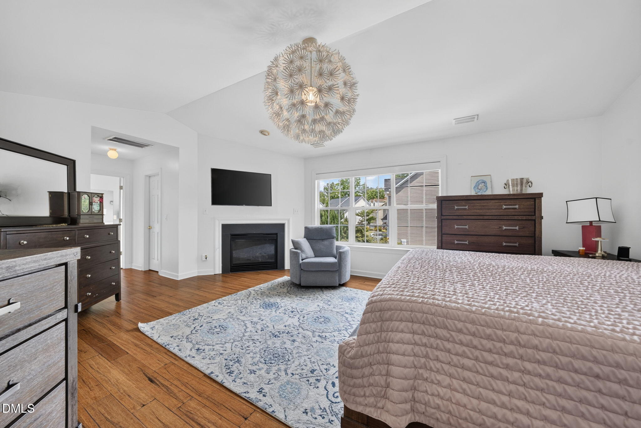 1258 Horsham Way Apex, NC 27502 - Photo 21 of 32 a bedroom with a bed and a fireplace
