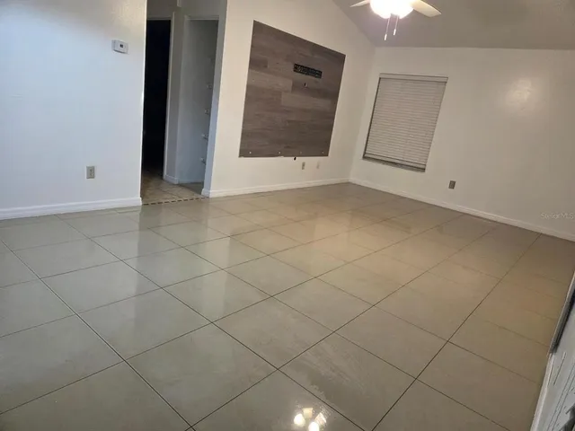 a kitchen with stainless steel appliances granite countertop a stove top oven a sink a microwave and a refrigerator