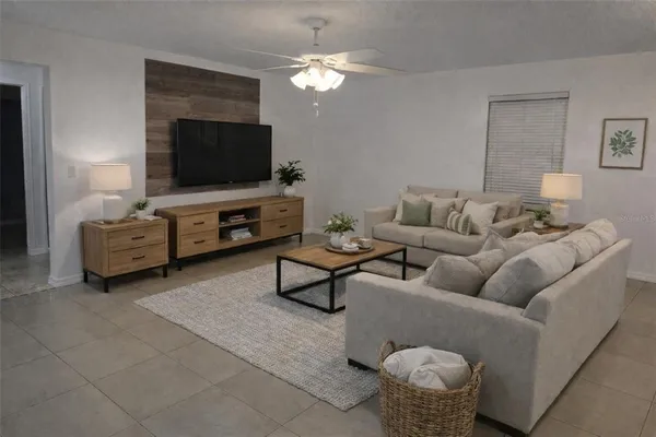 a living room with furniture and a flat screen tv