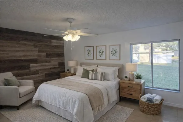 a bedroom with a bed and a chandelier