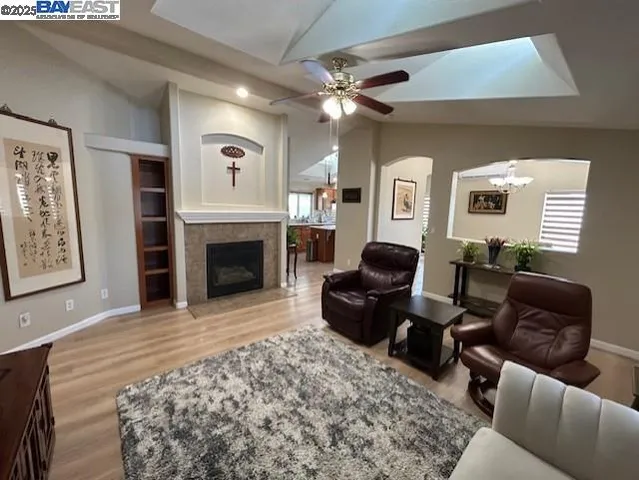 a living room with furniture a fireplace and a flat screen tv