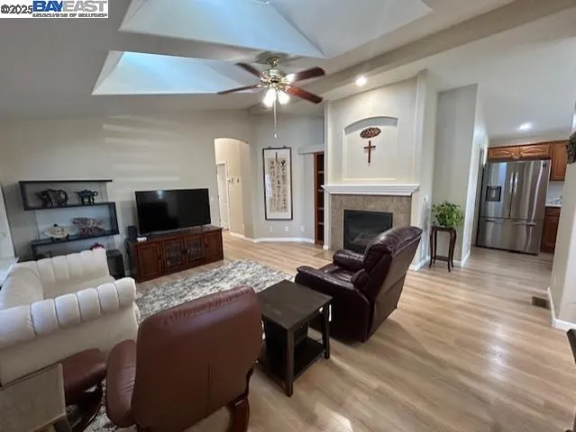 a living room with furniture a flat screen tv and a fireplace