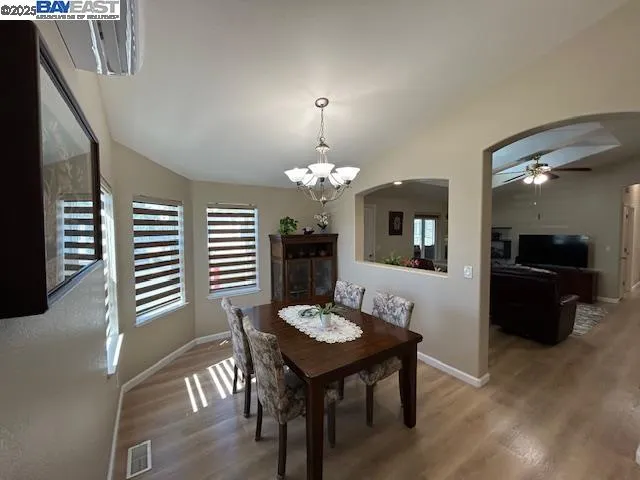 a view of a dining room with furniture and wooden floor