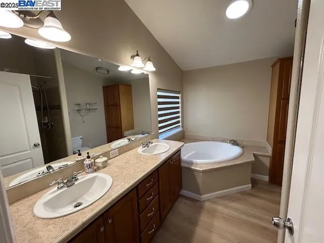 a bathroom with a double vanity sink and a mirror