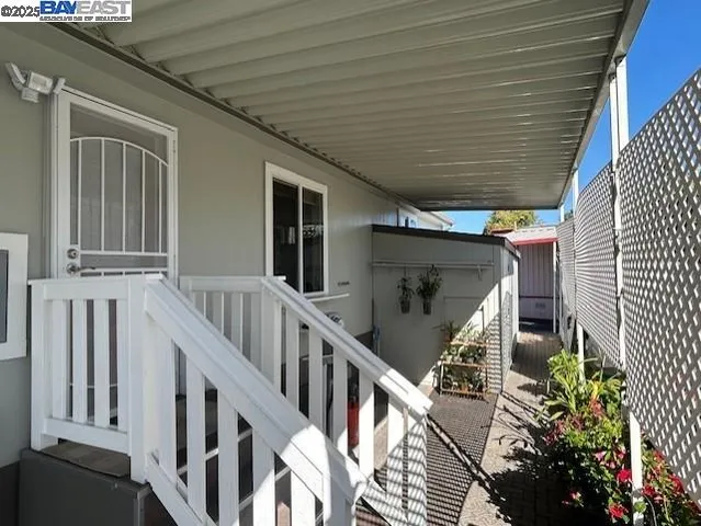 a roof deck with table and chairs potted plants