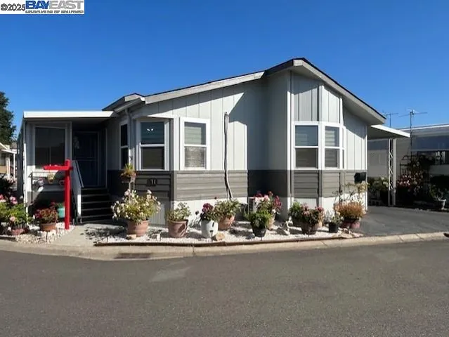 a view of a house with swimming pool and sitting area
