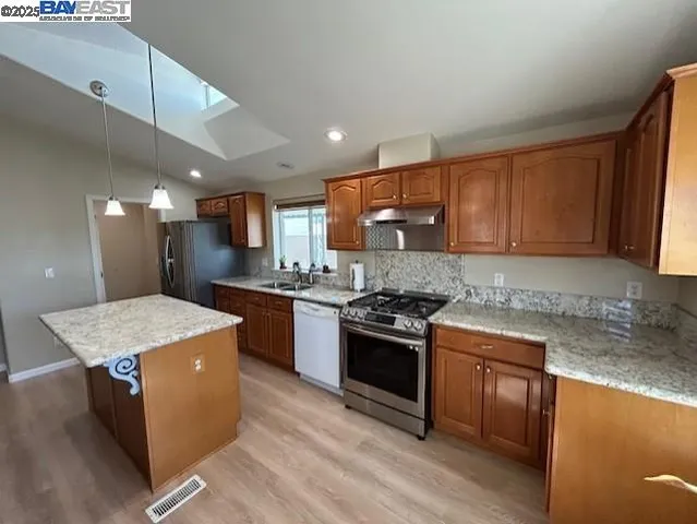 a kitchen with a stove sink and a refrigerator