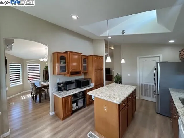 a kitchen with granite countertop a stove and a refrigerator