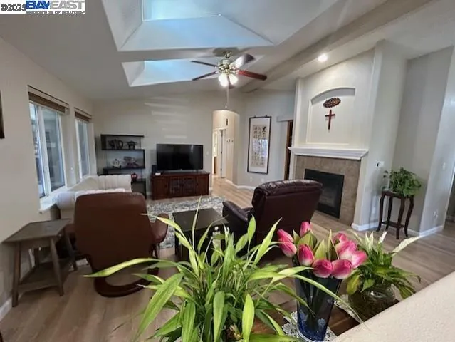 a living room with furniture a flat screen tv and a fireplace
