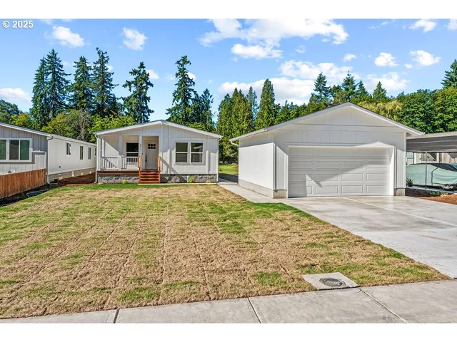 a view of a white house with a yard