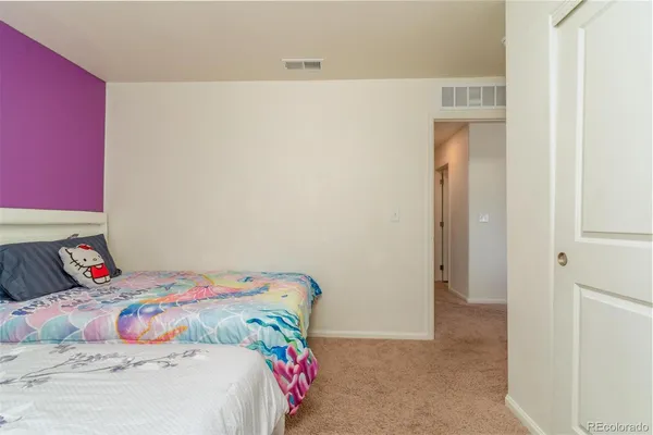 a bedroom with a bed and a dresser