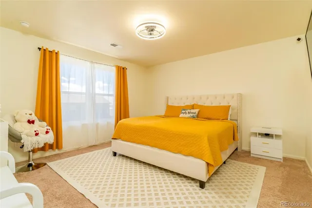 a bedroom with a bed and window