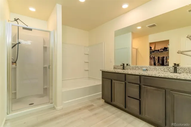 a bathroom with a granite countertop sink mirror and shower