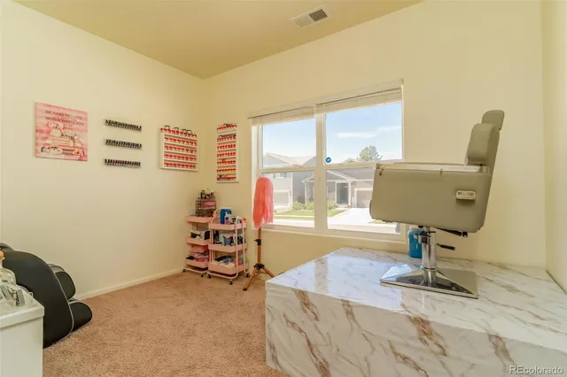a room with gym equipment and view of living room