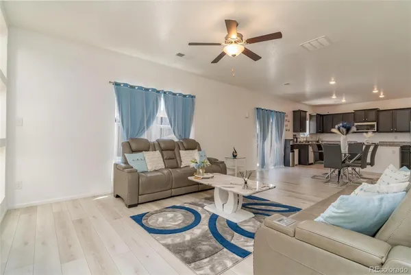 a living room with furniture and wooden floor