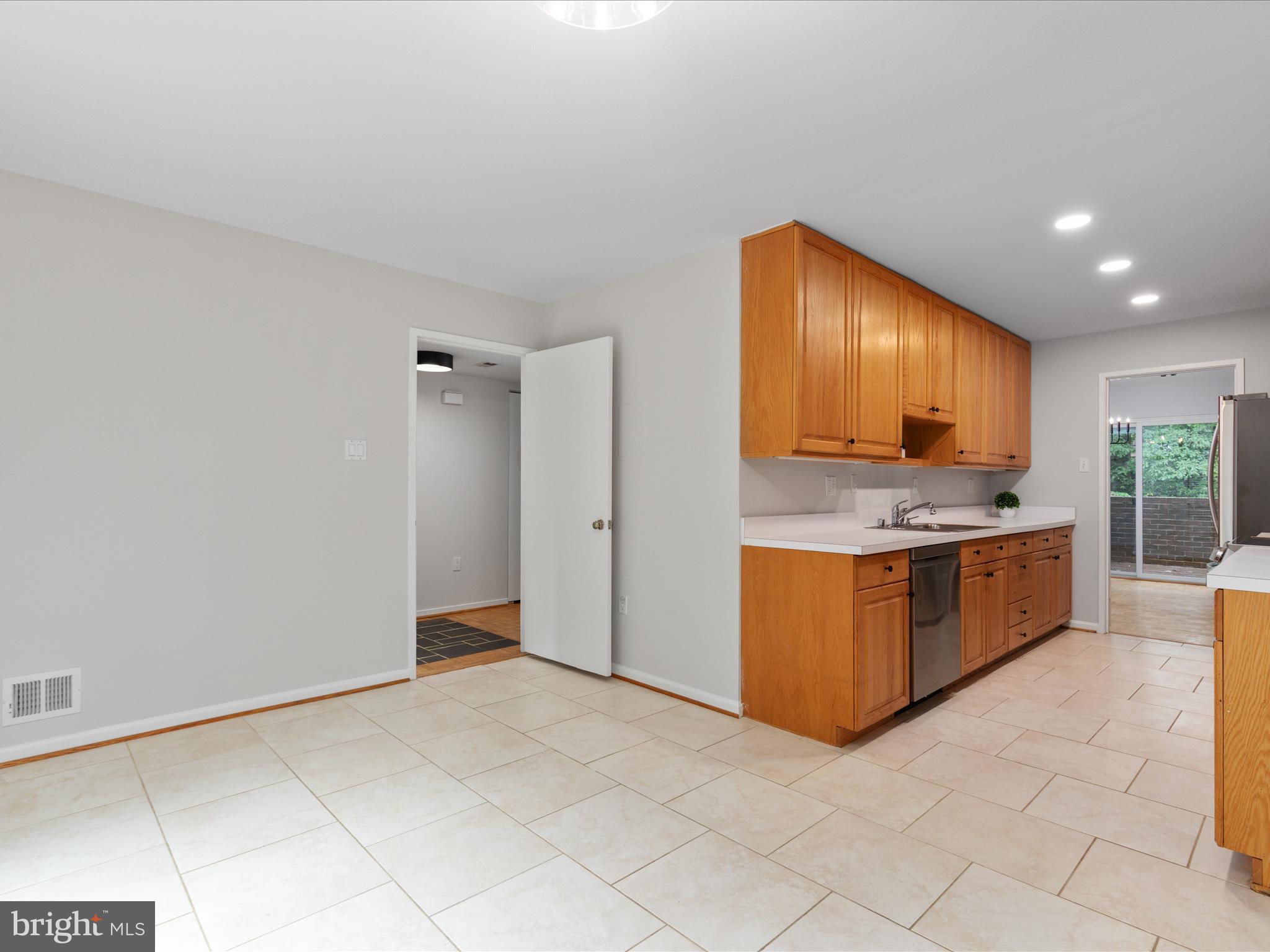 11726 Indian Ridge Road Reston, VA 20191 - Photo 12 of 67 a kitchen with stainless steel appliances granite countertop a stove a sink and a refrigerator