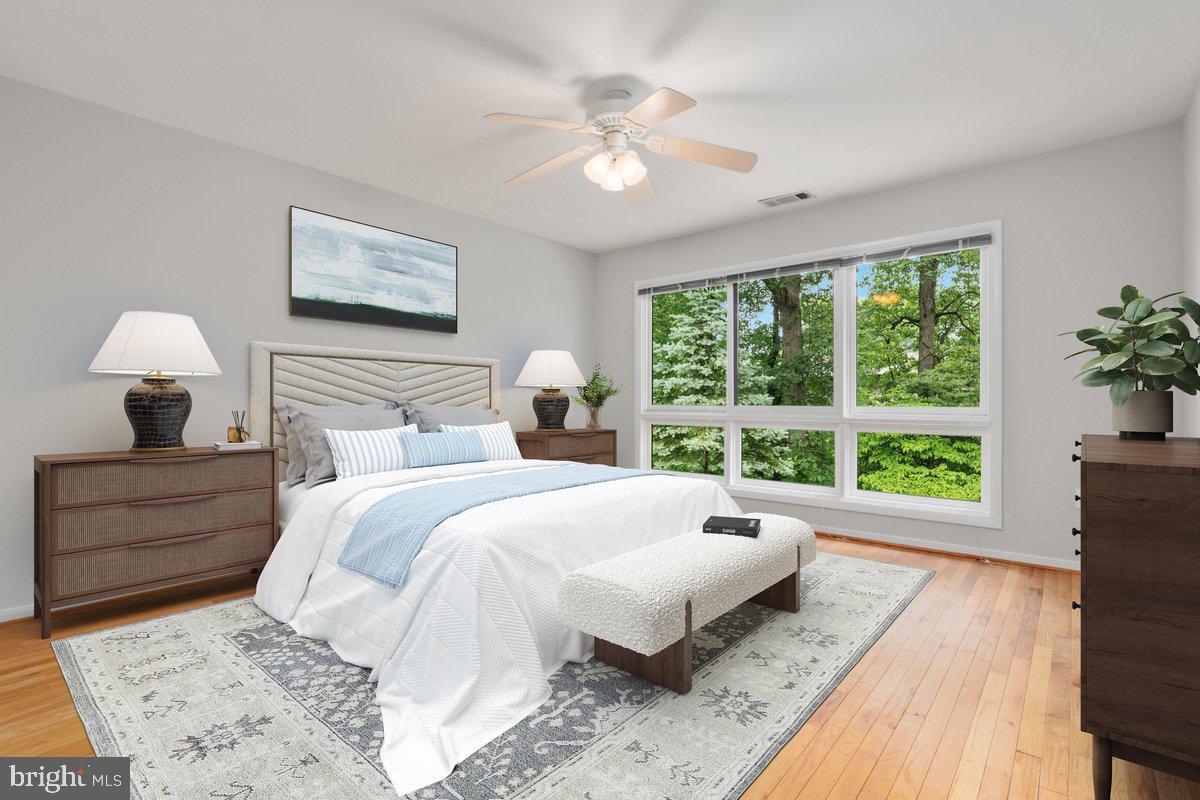 11726 Indian Ridge Road Reston, VA 20191 - Photo 16 of 67 a spacious bedroom with a bed and a large window