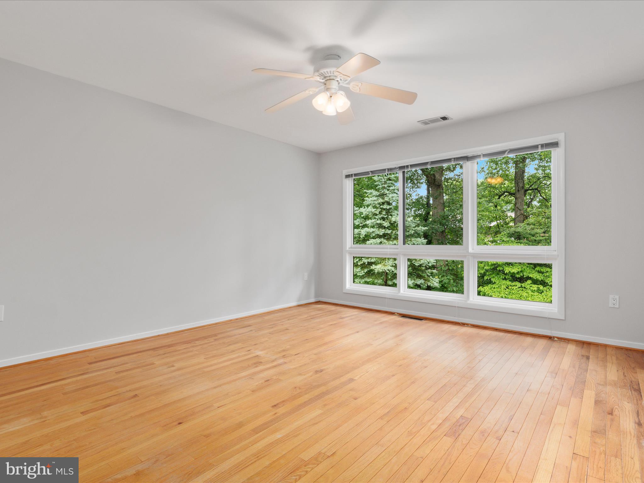 11726 Indian Ridge Road Reston, VA 20191 - Photo 17 of 67 a view of an empty room with wooden floor and a window