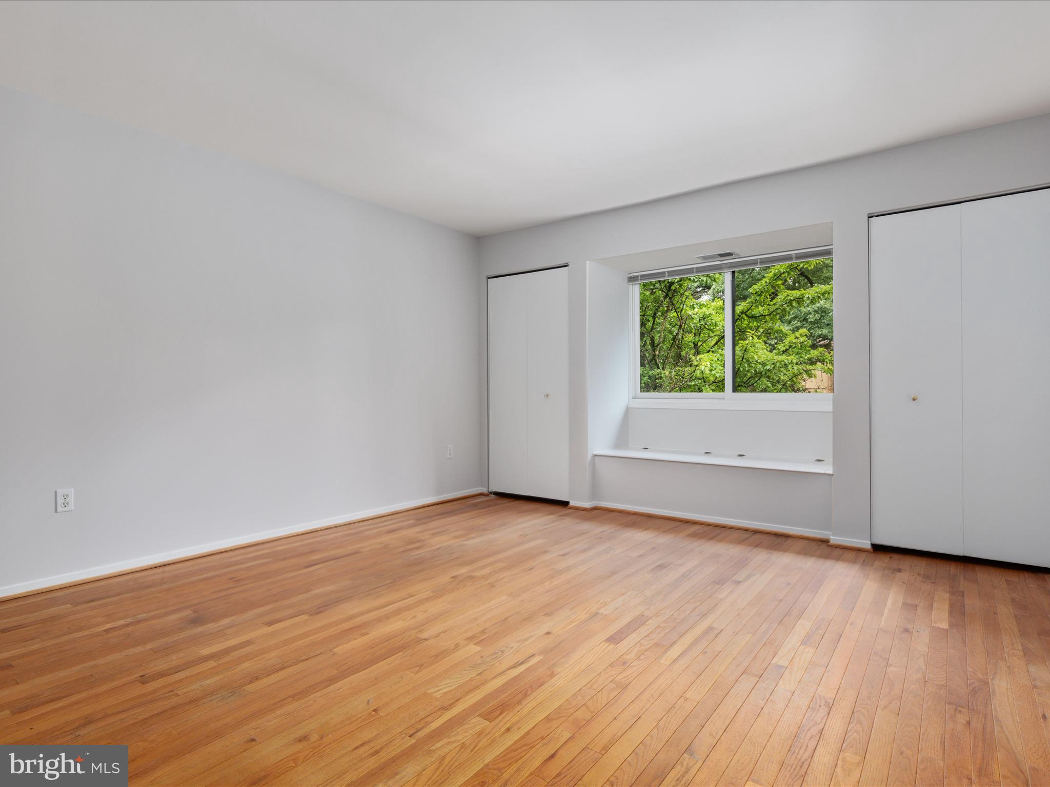 11726 Indian Ridge Road Reston, VA 20191 - Photo 21 of 67 a view of an empty room with wooden floor and a window