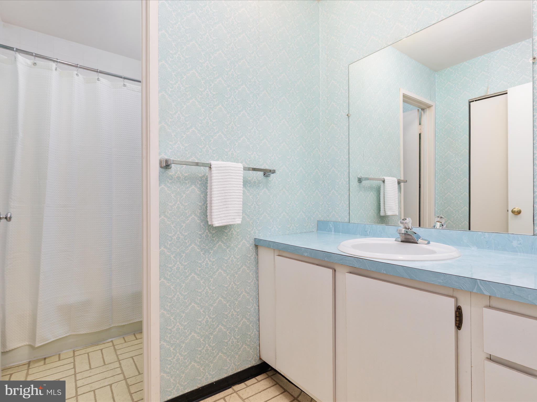 11726 Indian Ridge Road Reston, VA 20191 - Photo 23 of 67 a bathroom with a granite countertop sink and a mirror