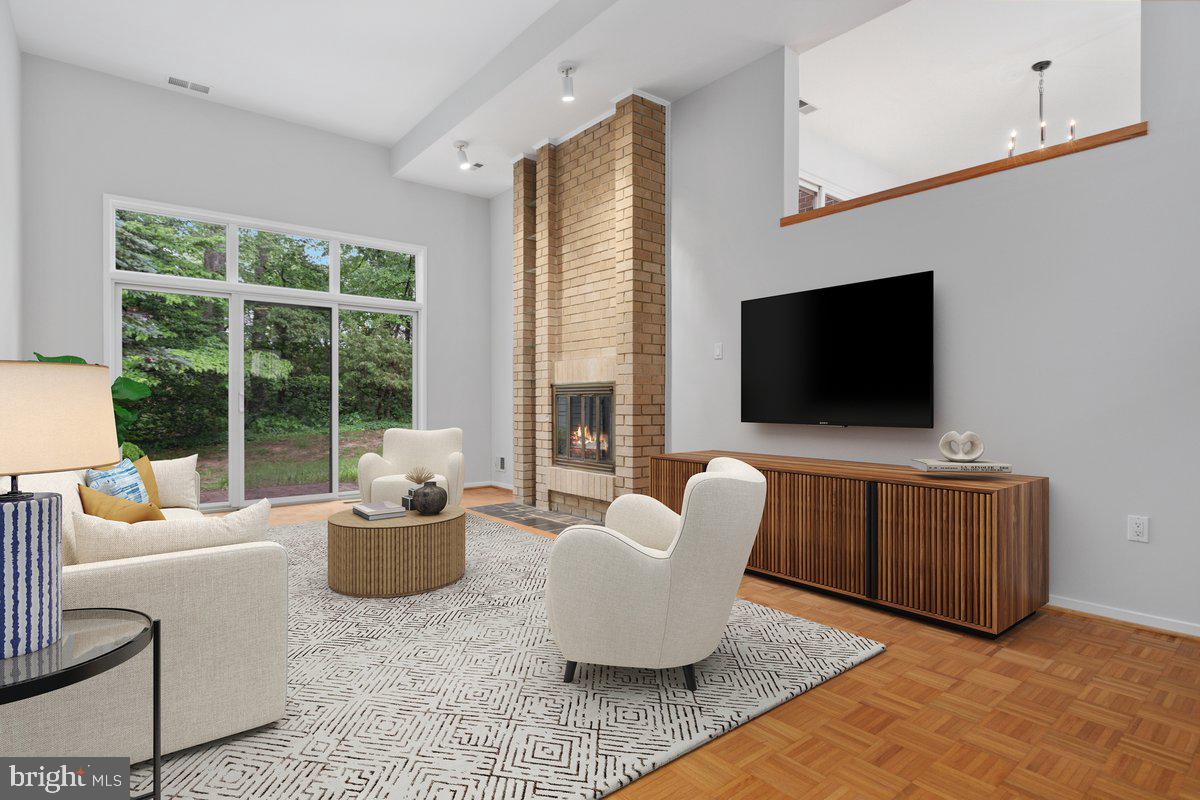 11726 Indian Ridge Road Reston, VA 20191 - Photo 24 of 67 a living room with furniture and a flat screen tv