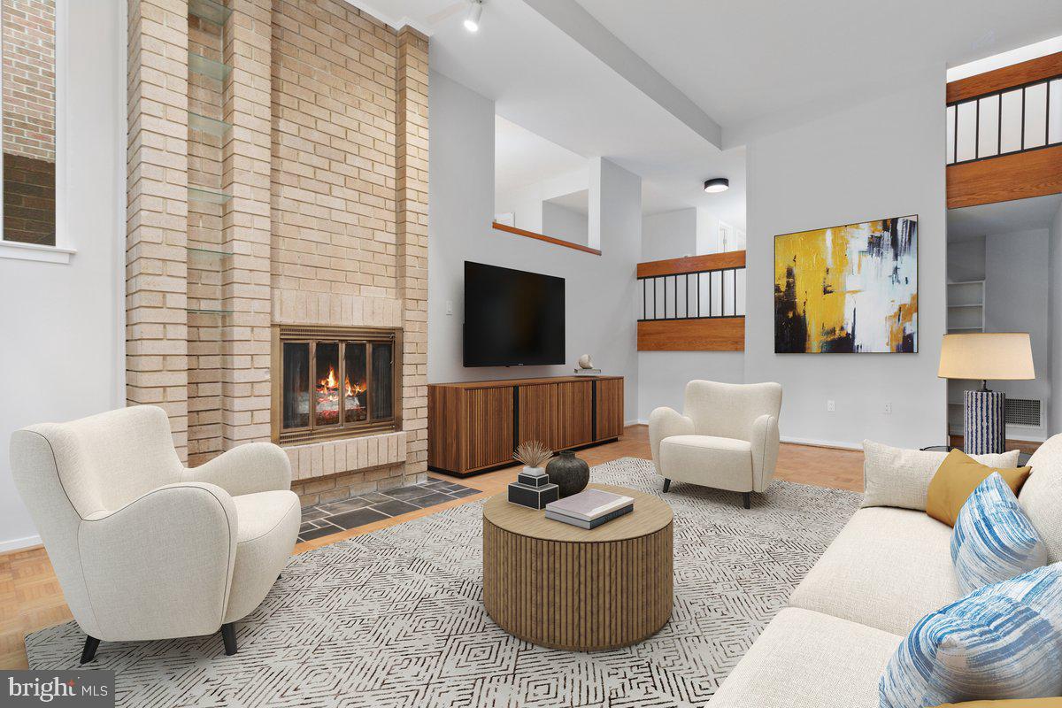 11726 Indian Ridge Road Reston, VA 20191 - Photo 27 of 67 a living room with furniture flat screen tv and a fireplace
