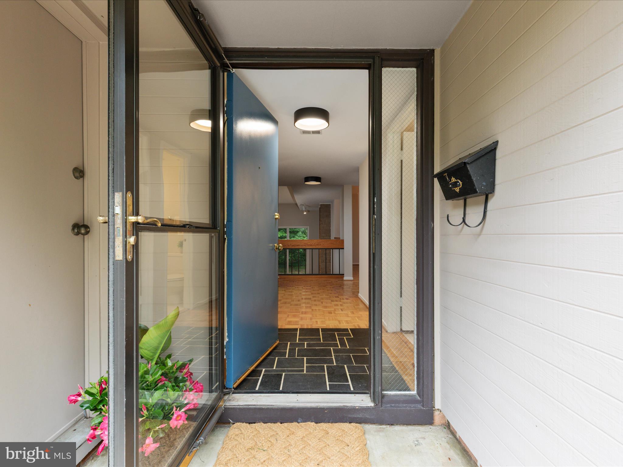 11726 Indian Ridge Road Reston, VA 20191 - Photo 4 of 67 a view of a hallway view with wooden floor and staircase