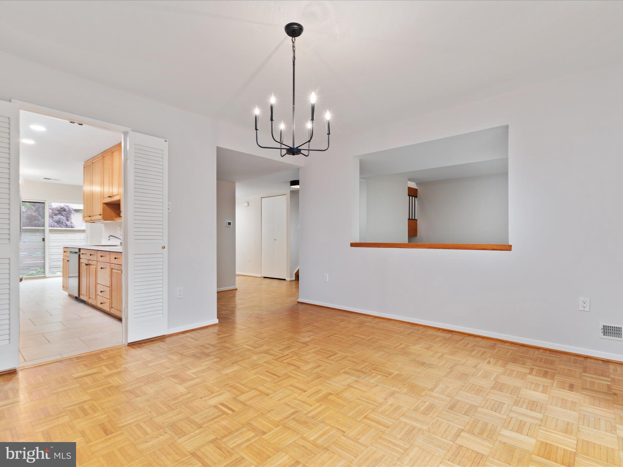 11726 Indian Ridge Road Reston, VA 20191 - Photo 8 of 67 a view of a hallway with wooden floor and a kitchen