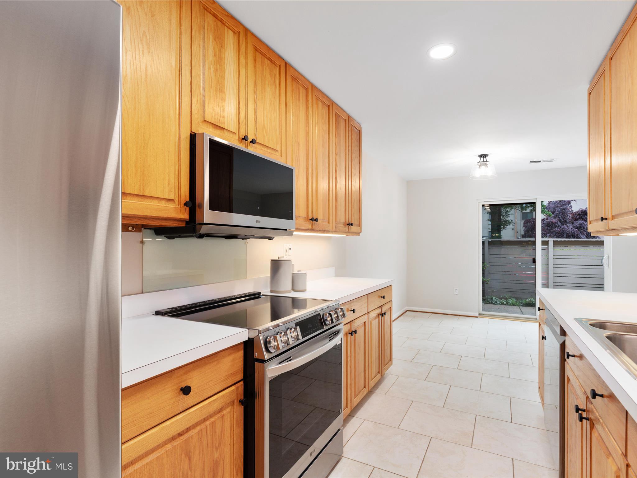 11726 Indian Ridge Road Reston, VA 20191 - Photo 9 of 67 a kitchen with stainless steel appliances granite countertop a sink and a stove