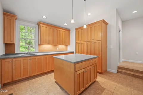 a kitchen that has a cabinets and wooden floor