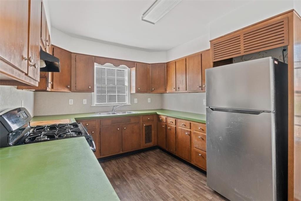 449 10th Street Northwest Atlanta, GA 30318 - Photo 11 of 40 a kitchen with stainless steel appliances granite countertop a refrigerator and a sink