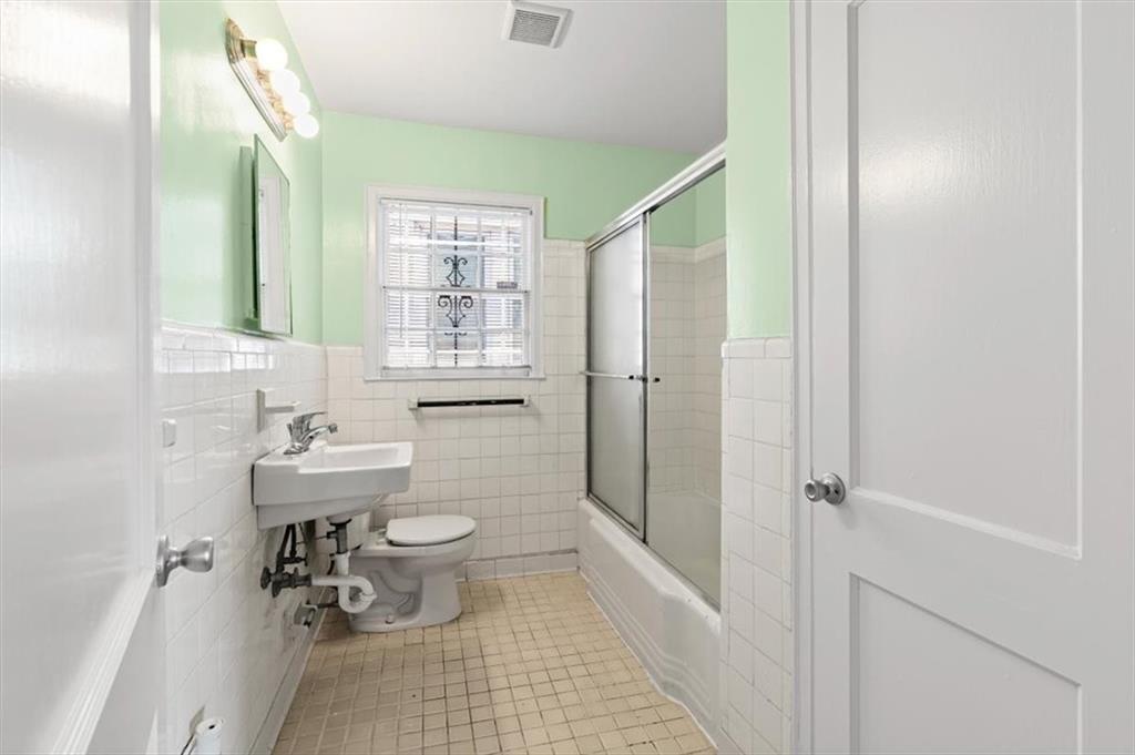 449 10th Street Northwest Atlanta, GA 30318 - Photo 18 of 40 a bathroom with a sink a toilet and shower