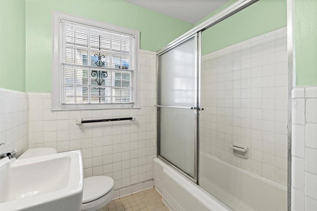 449 10th Street Northwest Atlanta, GA 30318 - Photo 19 of 40 a bathroom with a shower and a toilet