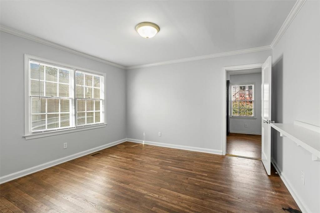 449 10th Street Northwest Atlanta, GA 30318 - Photo 22 of 40 a view of an empty room with wooden floor and a window