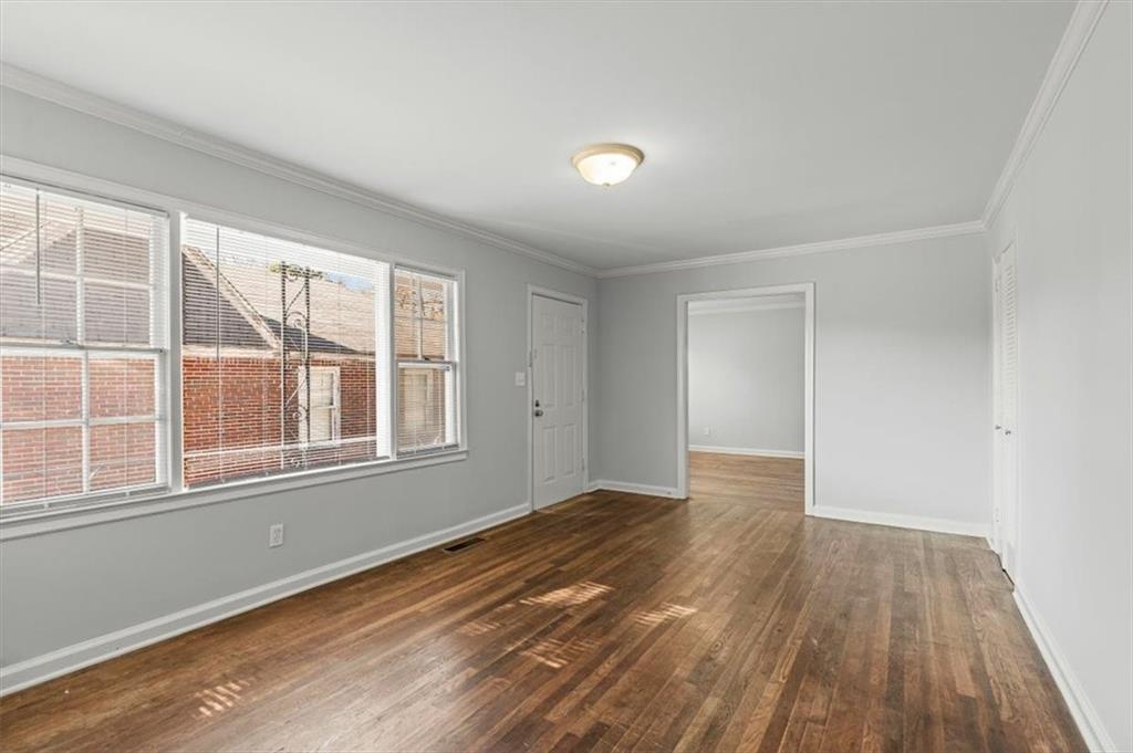 449 10th Street Northwest Atlanta, GA 30318 - Photo 6 of 40 a view of an empty room with wooden floor and a window