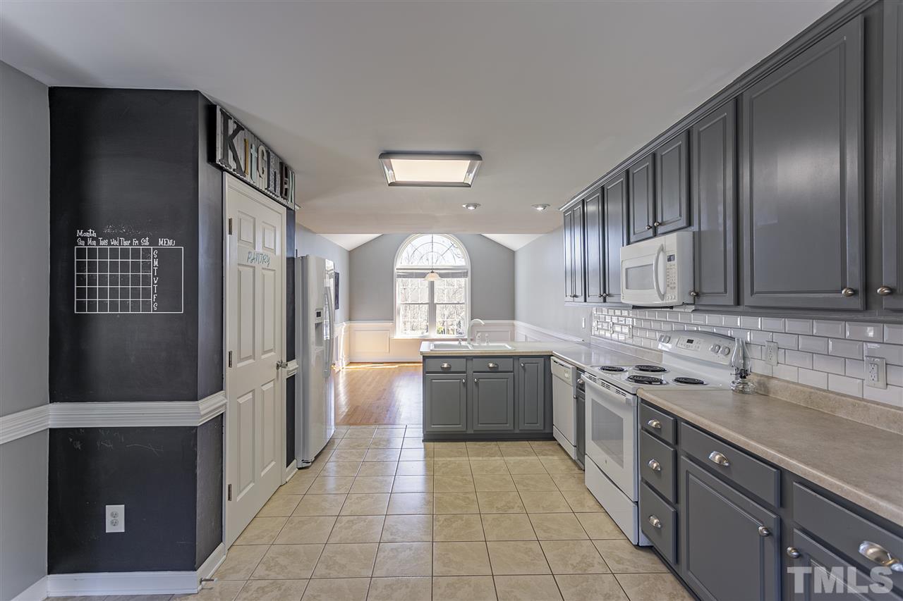 156 Fork Junction Road Timberlake, NC 27583 - Photo 15 of 30 a large kitchen with a sink and dishwasher a refrigerator with wooden cabinets
