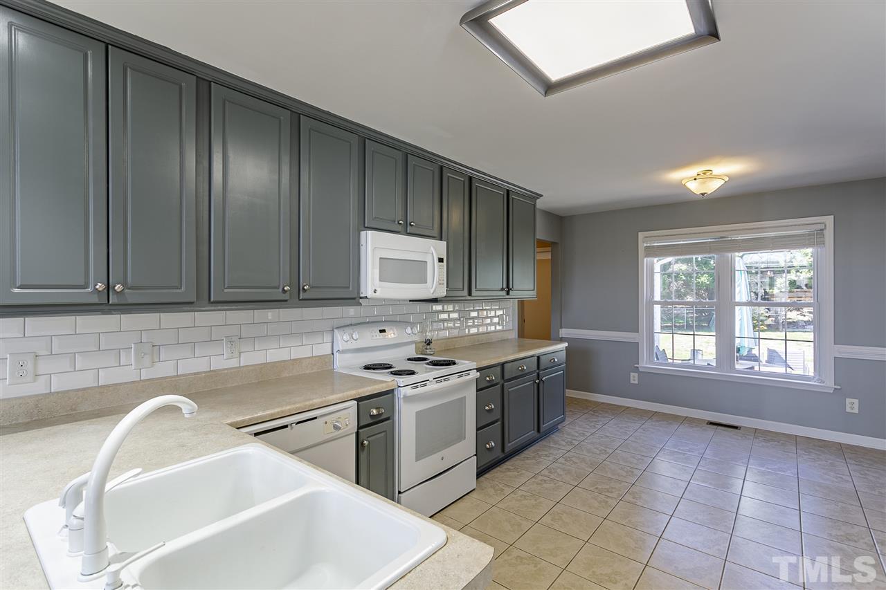 156 Fork Junction Road Timberlake, NC 27583 - Photo 16 of 30 a kitchen with a sink stove and cabinets