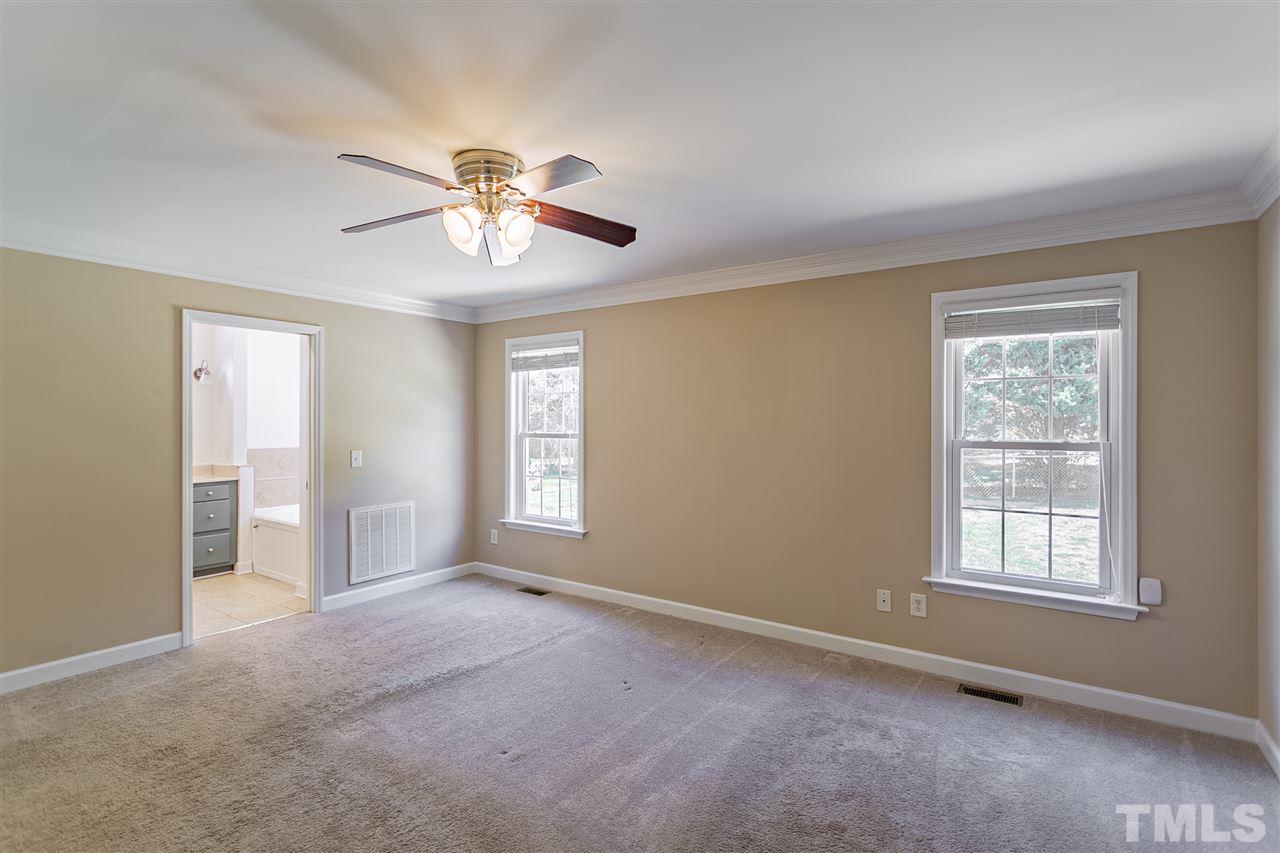 156 Fork Junction Road Timberlake, NC 27583 - Photo 19 of 30 a view of a livingroom with a chandelier fan and windows