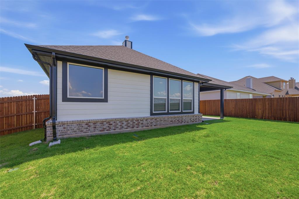 1213 Colca Drive Springtown, TX 76082 - Photo 22 of 23 Expansive green lawn bordering the rear exterior