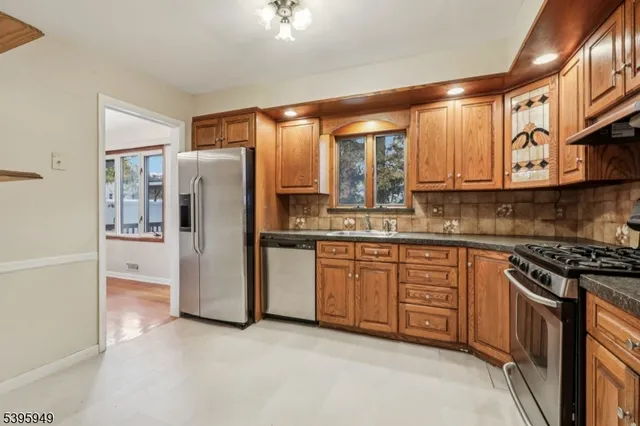 a kitchen with stainless steel appliances granite countertop a stove and a refrigerator
