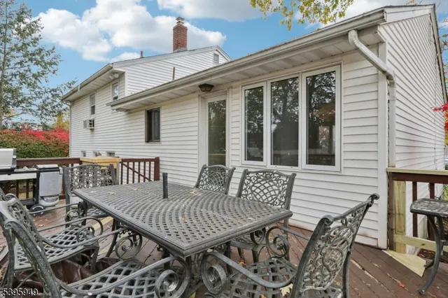 a view of a deck with furniture and trees