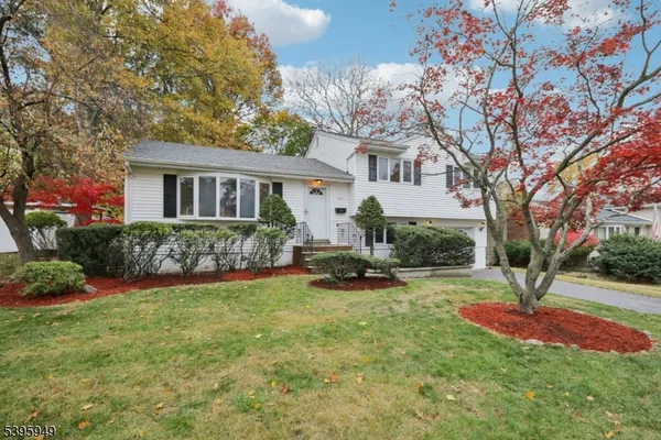 a front view of a house with a yard and porch
